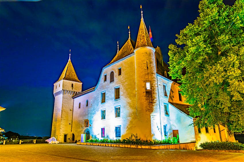 Night view of White Chateau de Nyon in Switzerland