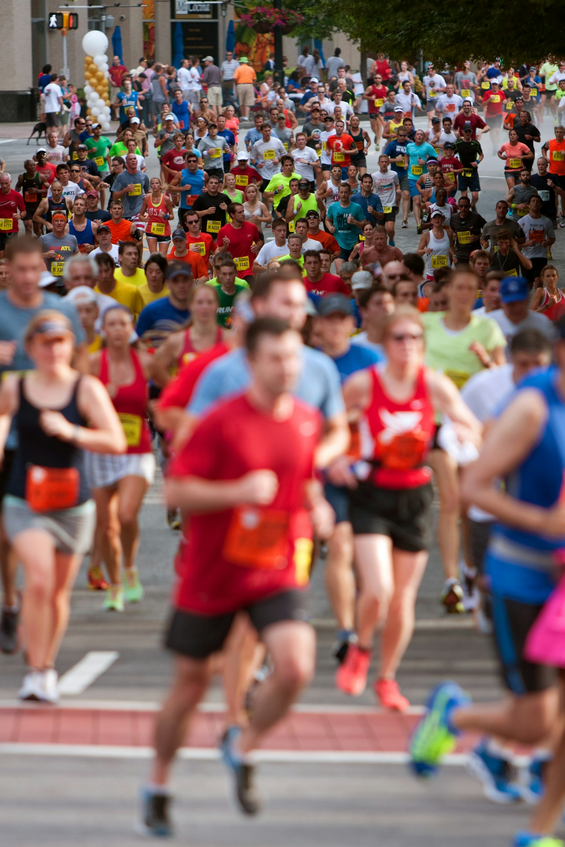 Thousands of runners make their way down Peachtree Street on their way to the finish line of the Peachtree Road Race