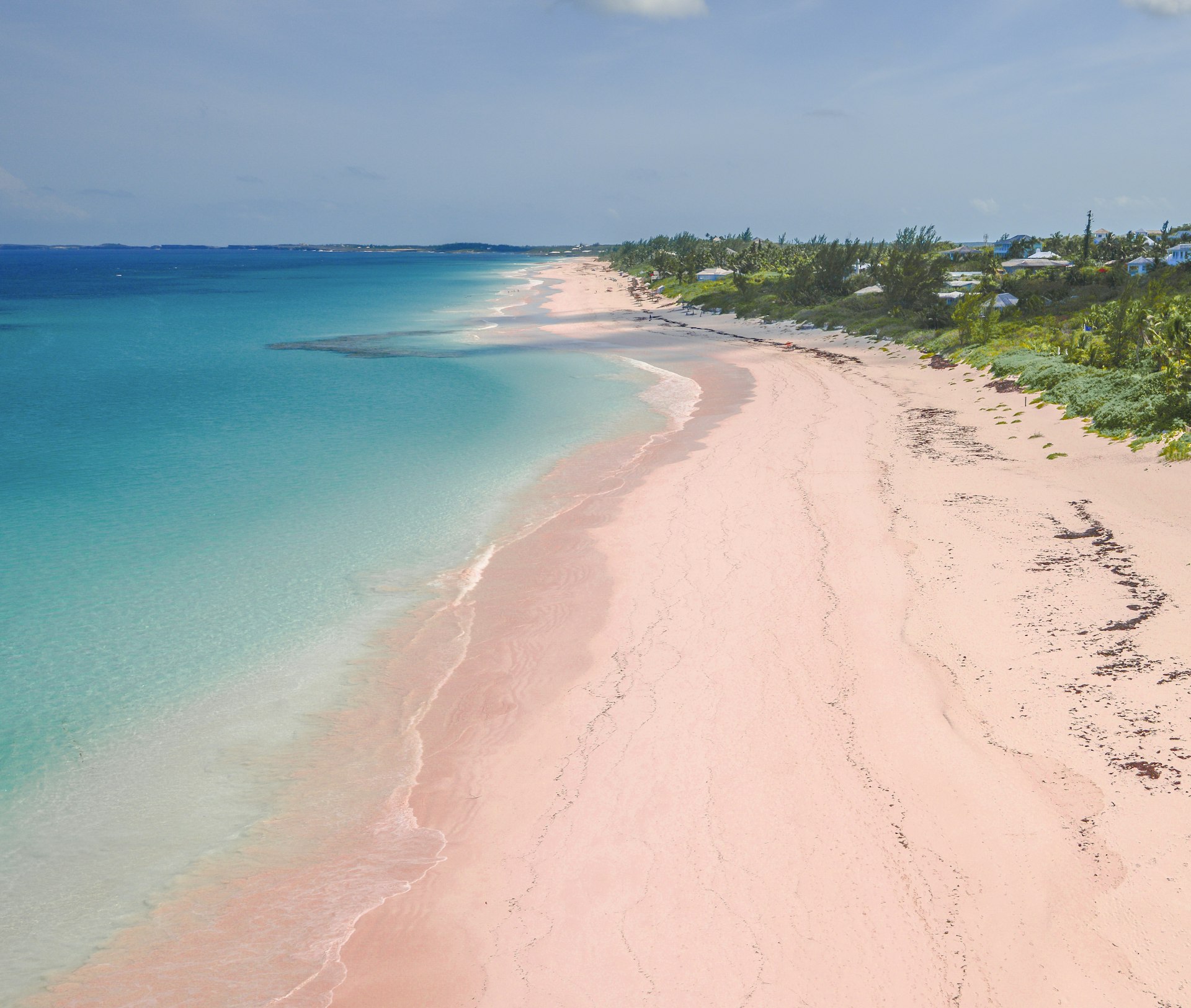 Aerial view of pink sand and blue waters of the aptly named Pink Sand Beach. The 