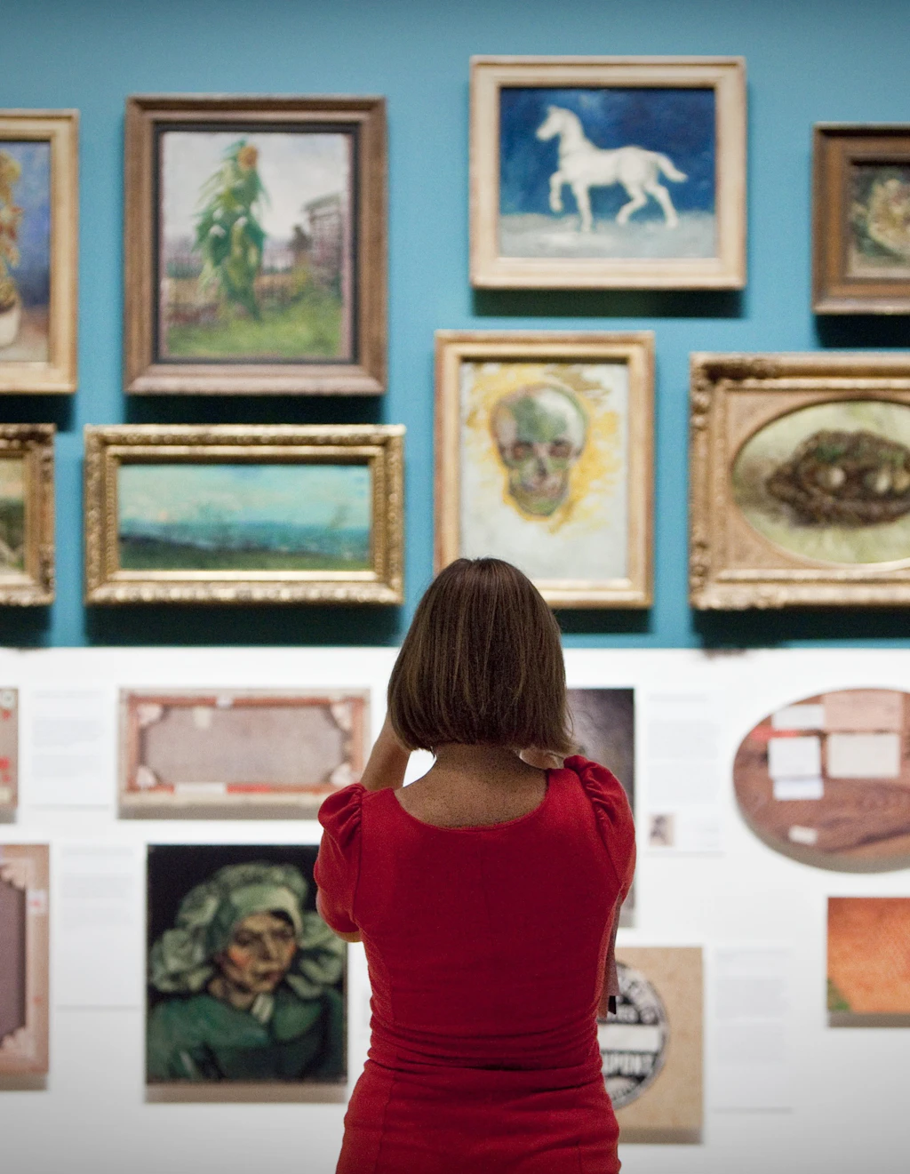 A woman looks at paintings of dutch painter Vincent van Gogh in the Van Gogh Museum in Amsterdam The Netherlands.