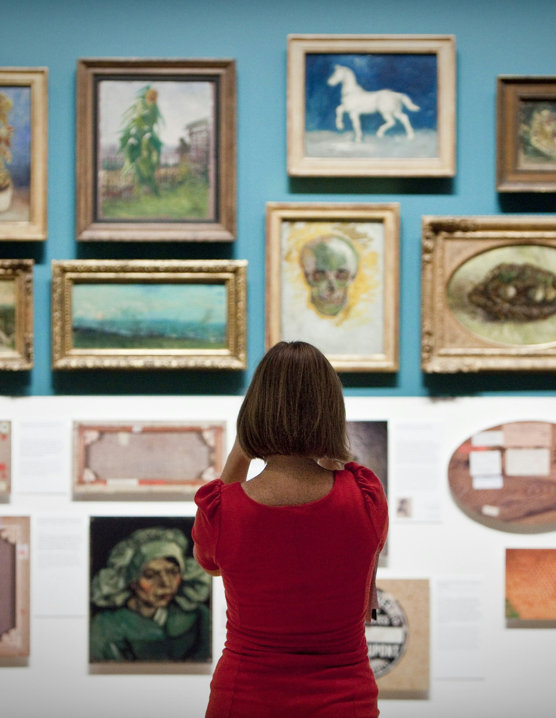 A woman looks at paintings of dutch painter Vincent van Gogh in the Van Gogh Museum in Amsterdam The Netherlands