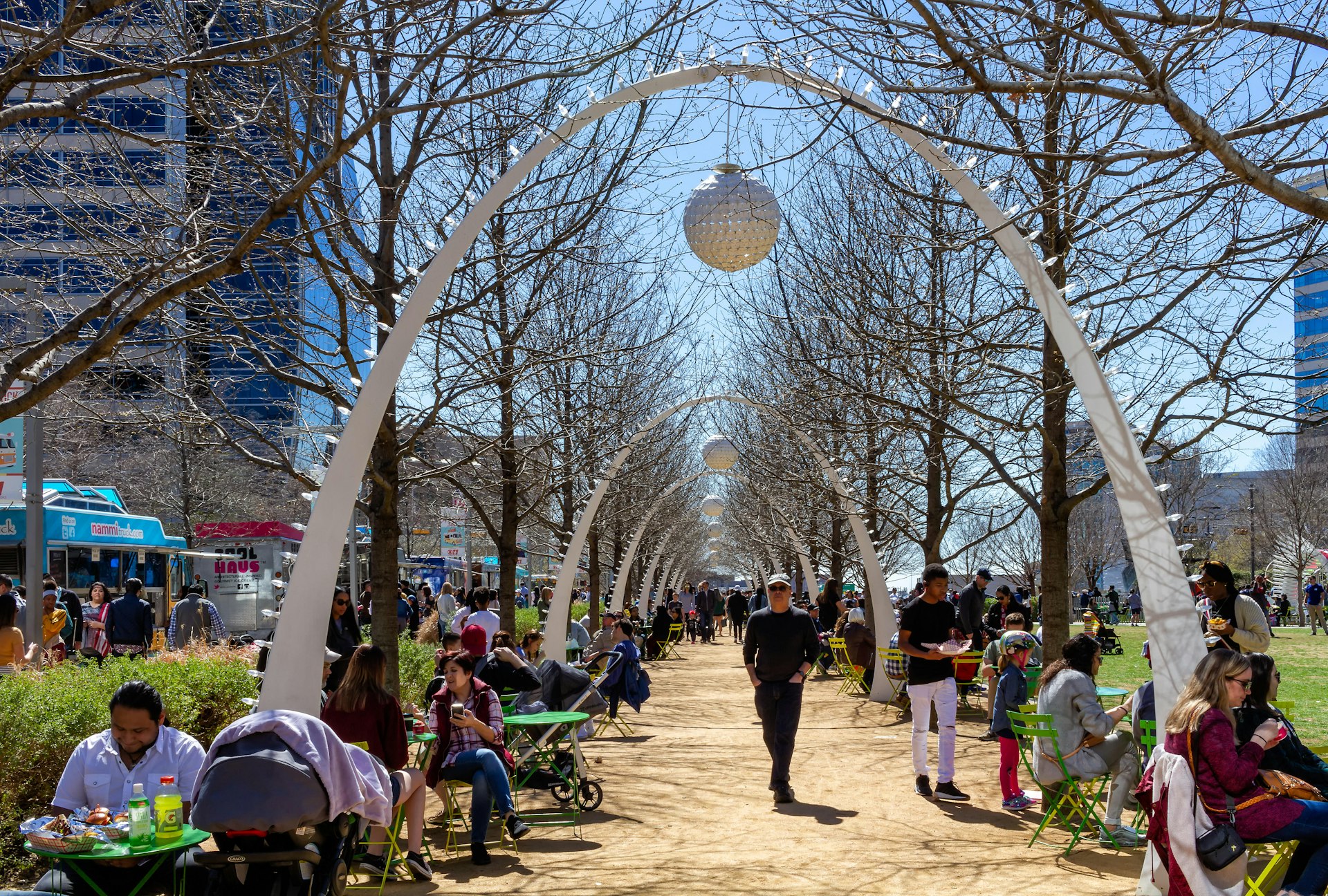 Dallas, Texas - USA - March 16, 2019: Sunny Spring day in Klyde Warren Park in Dallas. People eating in the foodtrucks.