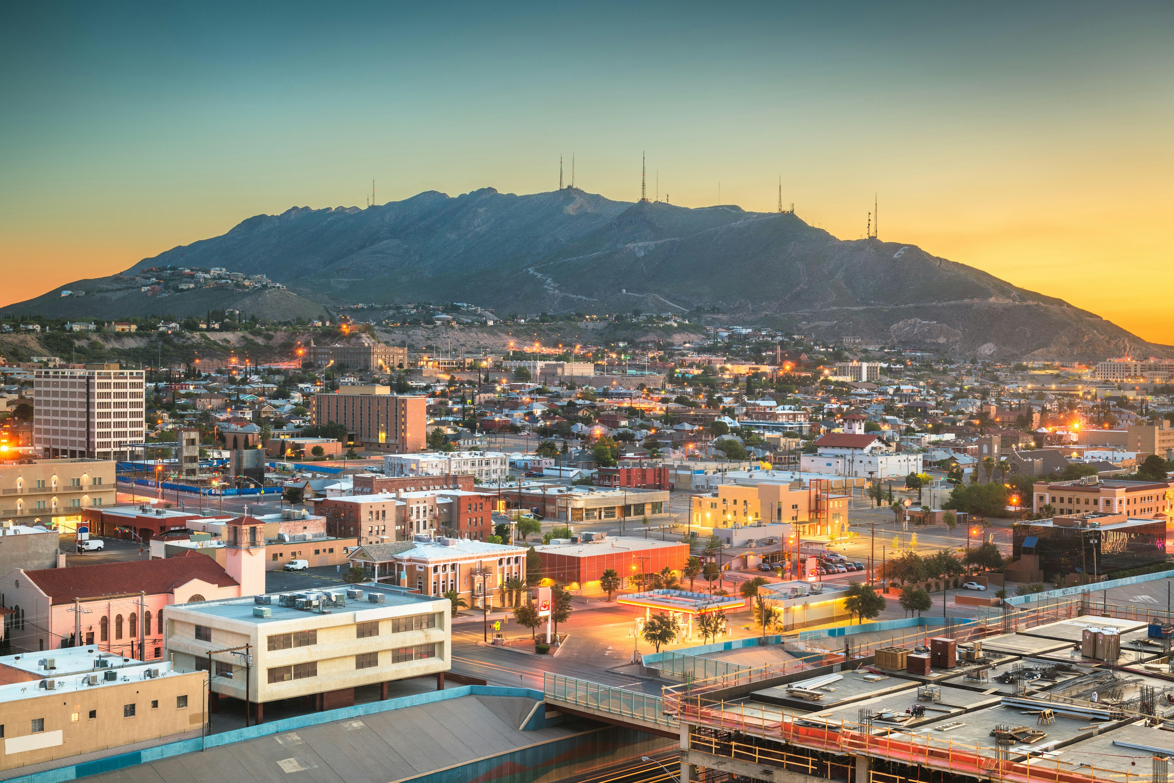 A view over the El Paso skyline at dawn, with mountains rising behind the city