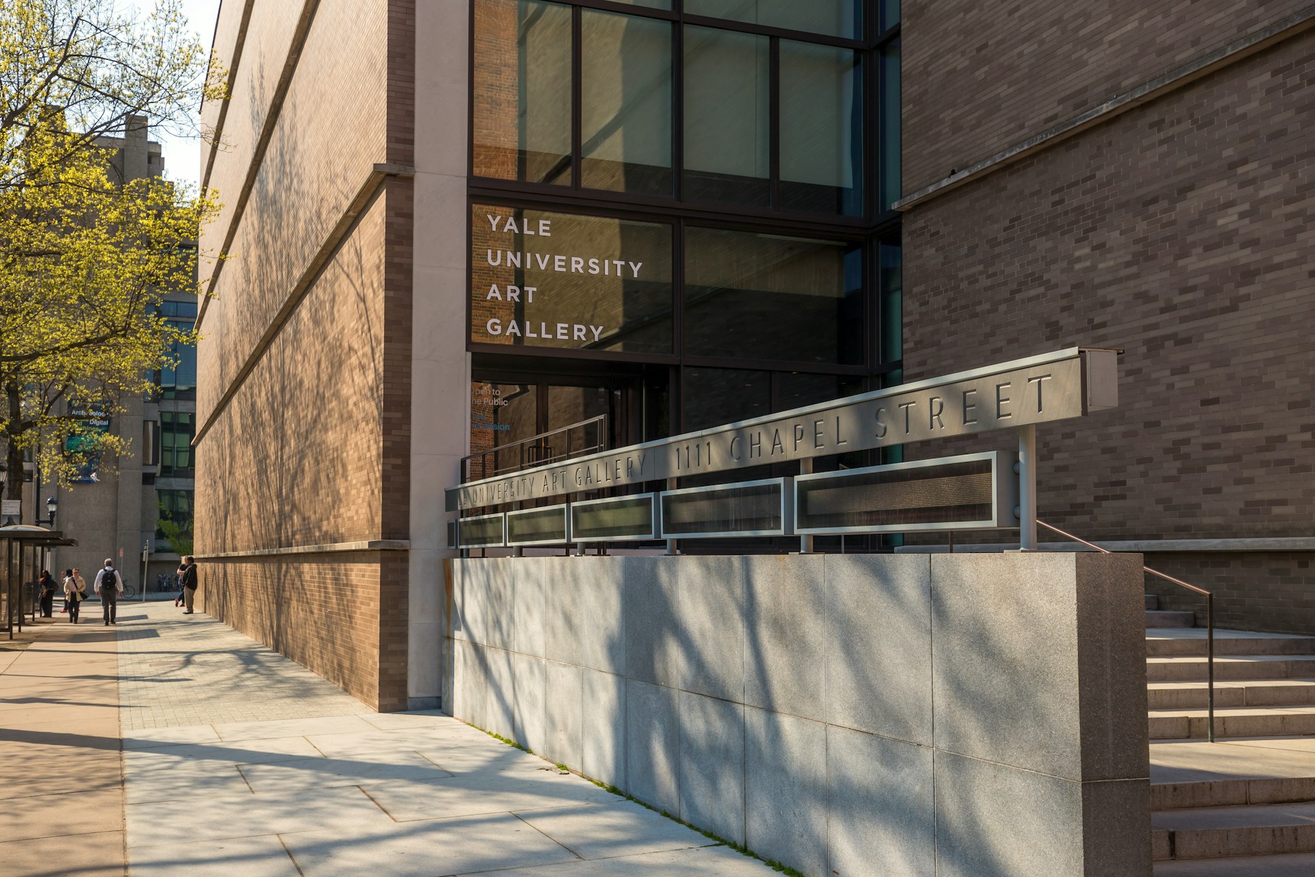 The entrance to Yale University Art Gallery, a sleek, modern-looking building with a sign showing the name of the gallery.