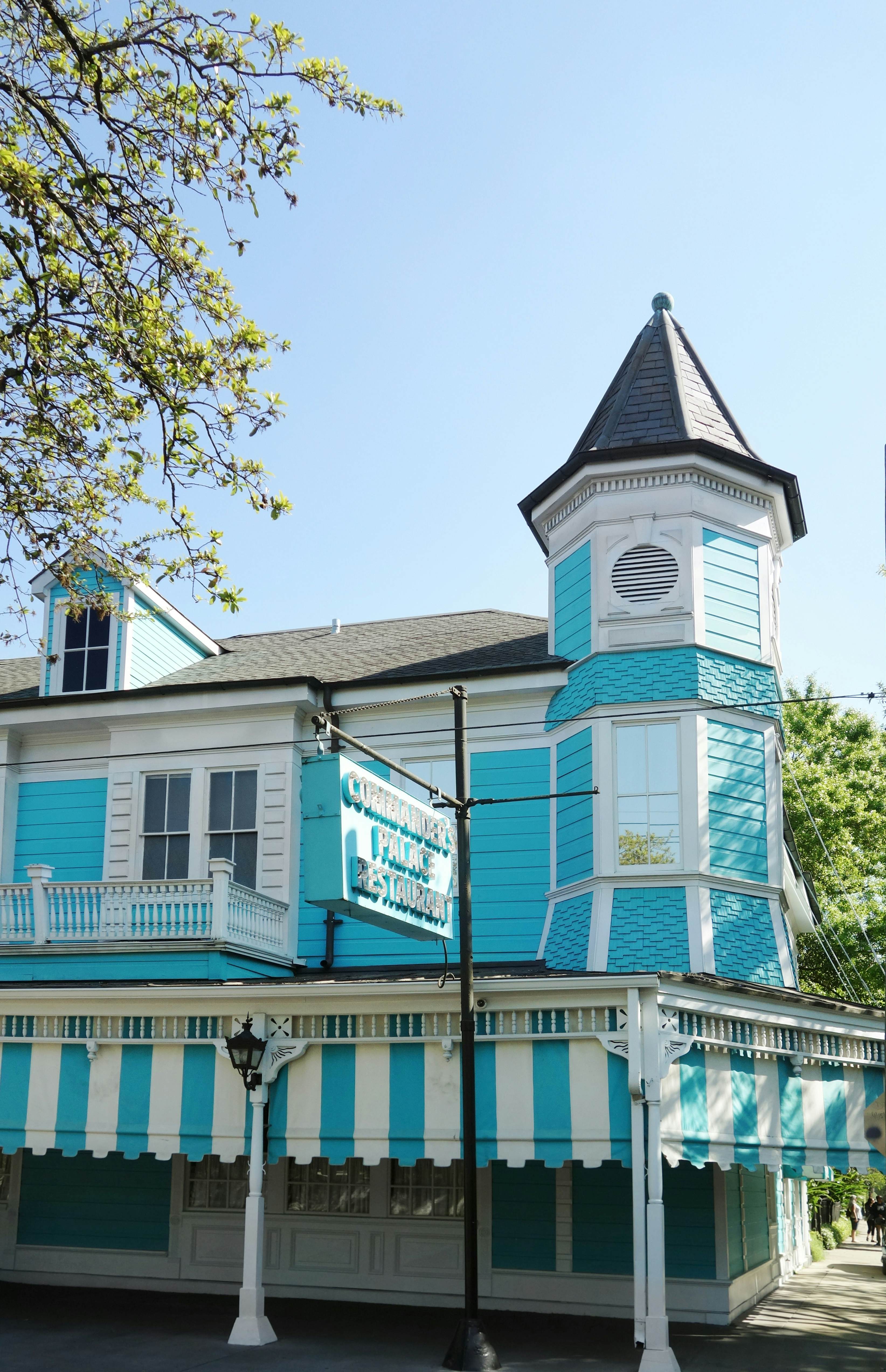 Turqoise and white exterior of the famous Commanders Palace restaurant in the Garden District neighborhood