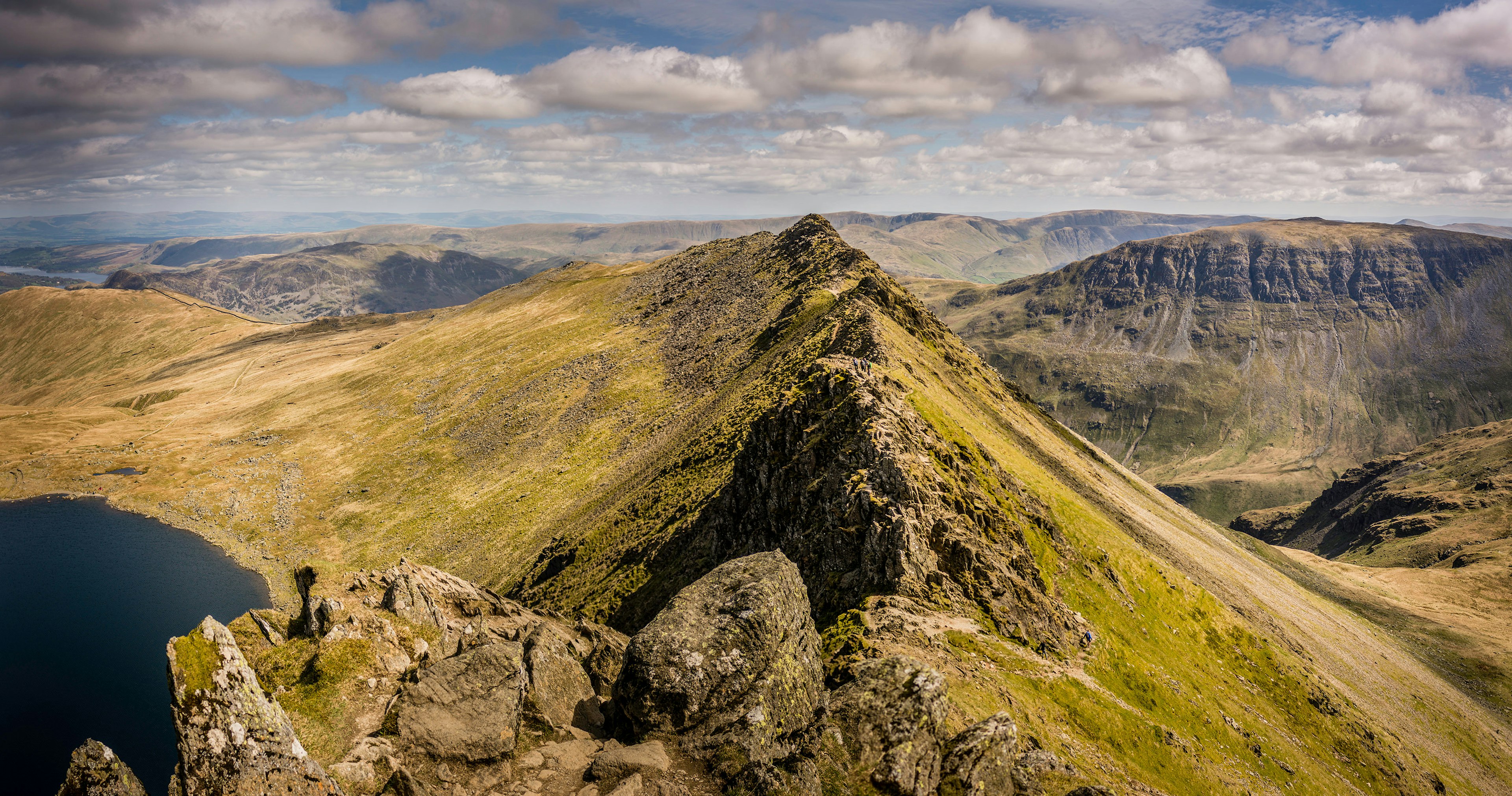 A green mountain ridge reaches into the distance.