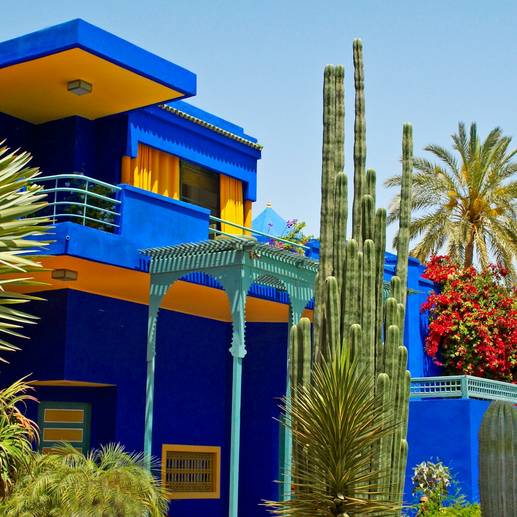 May 2012: Colourful modern exterior of the Jardin Majorelle museum building with varied plants in the garden.