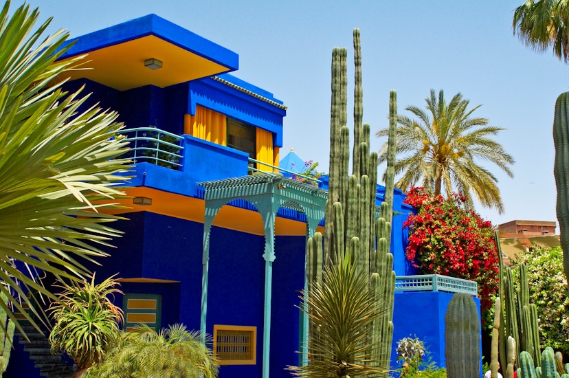 May 2012: Colourful modern exterior of the Jardin Majorelle museum building with varied plants in the garden.