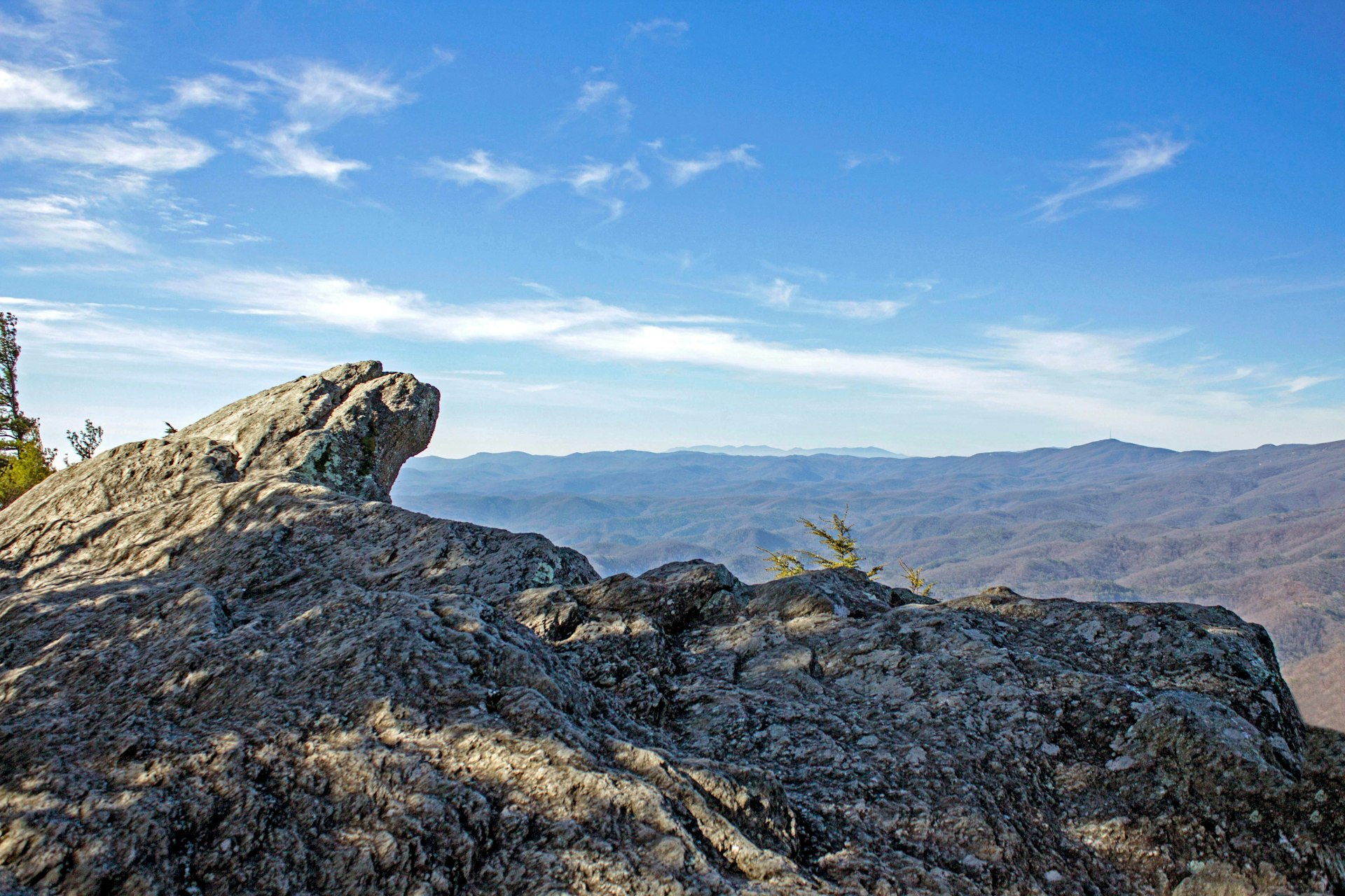 A rocky outcrop overlooking mountains