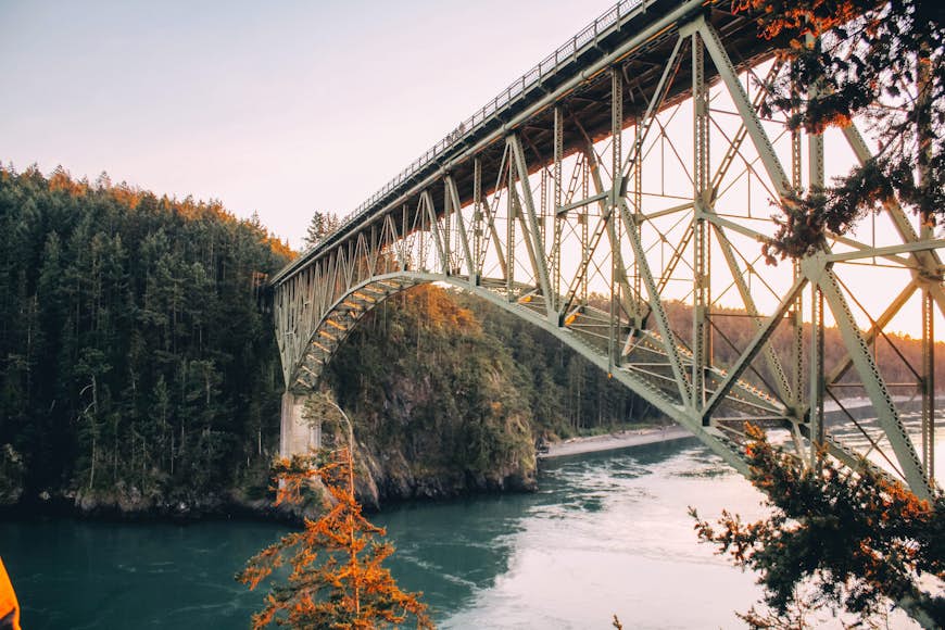 A high arched bridge connects two islands in the fall