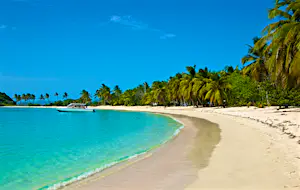 A tourist boat lies at anchor in a harbor on the Caribbean island of Mayreau.