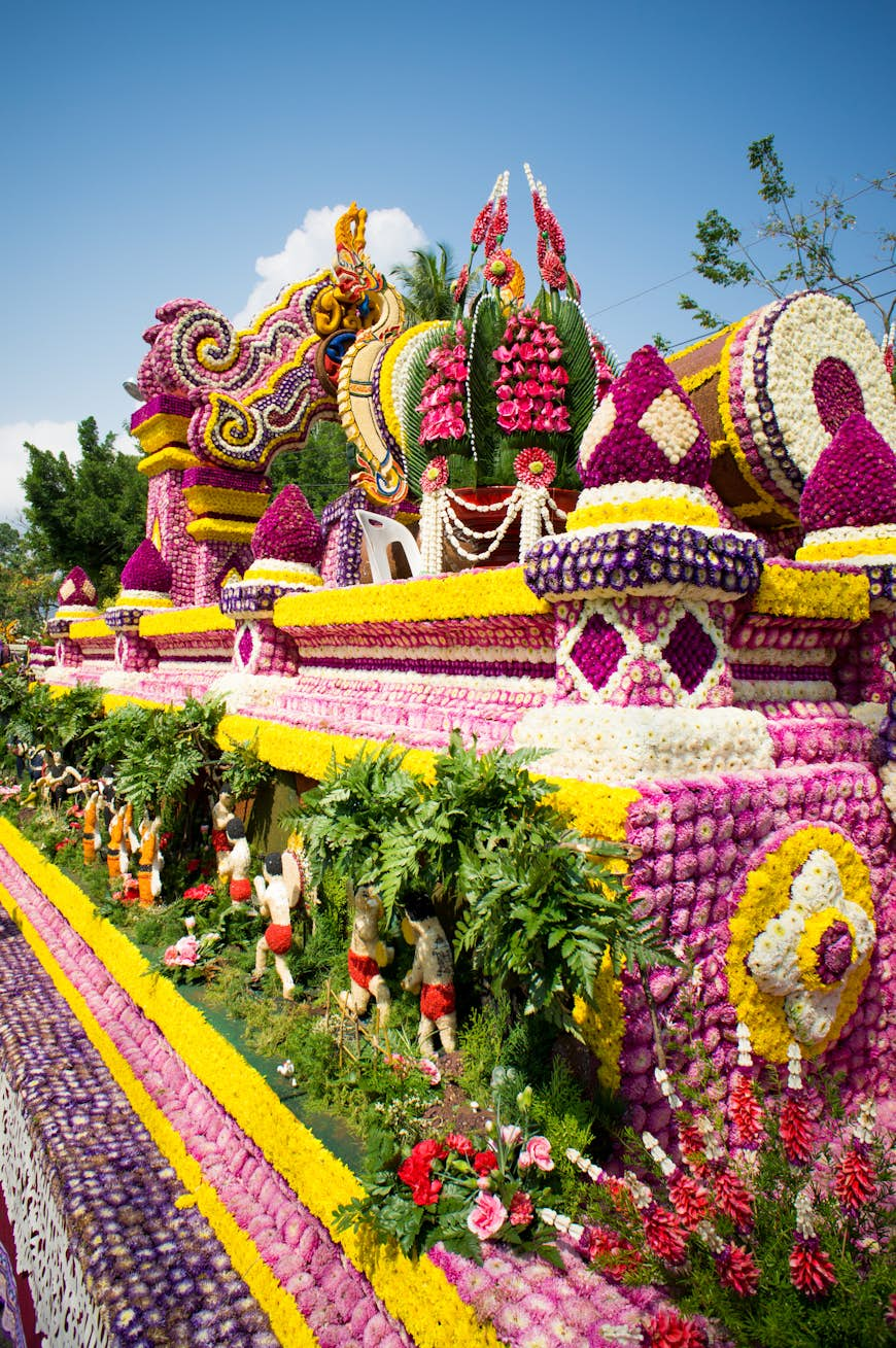 Brightly colored flower are arranged in a traditional manner. 