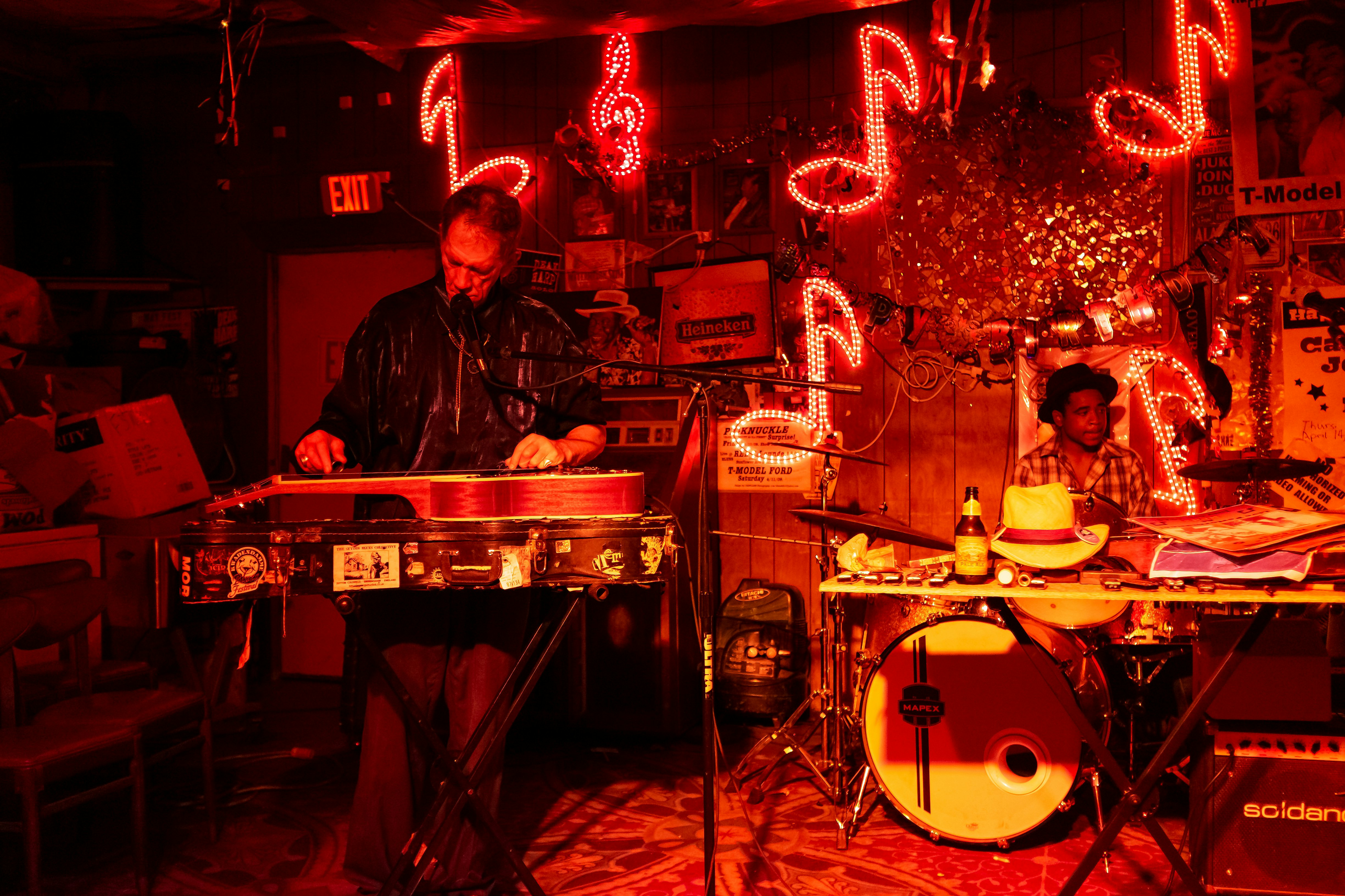 Blues musicians playing under red lights