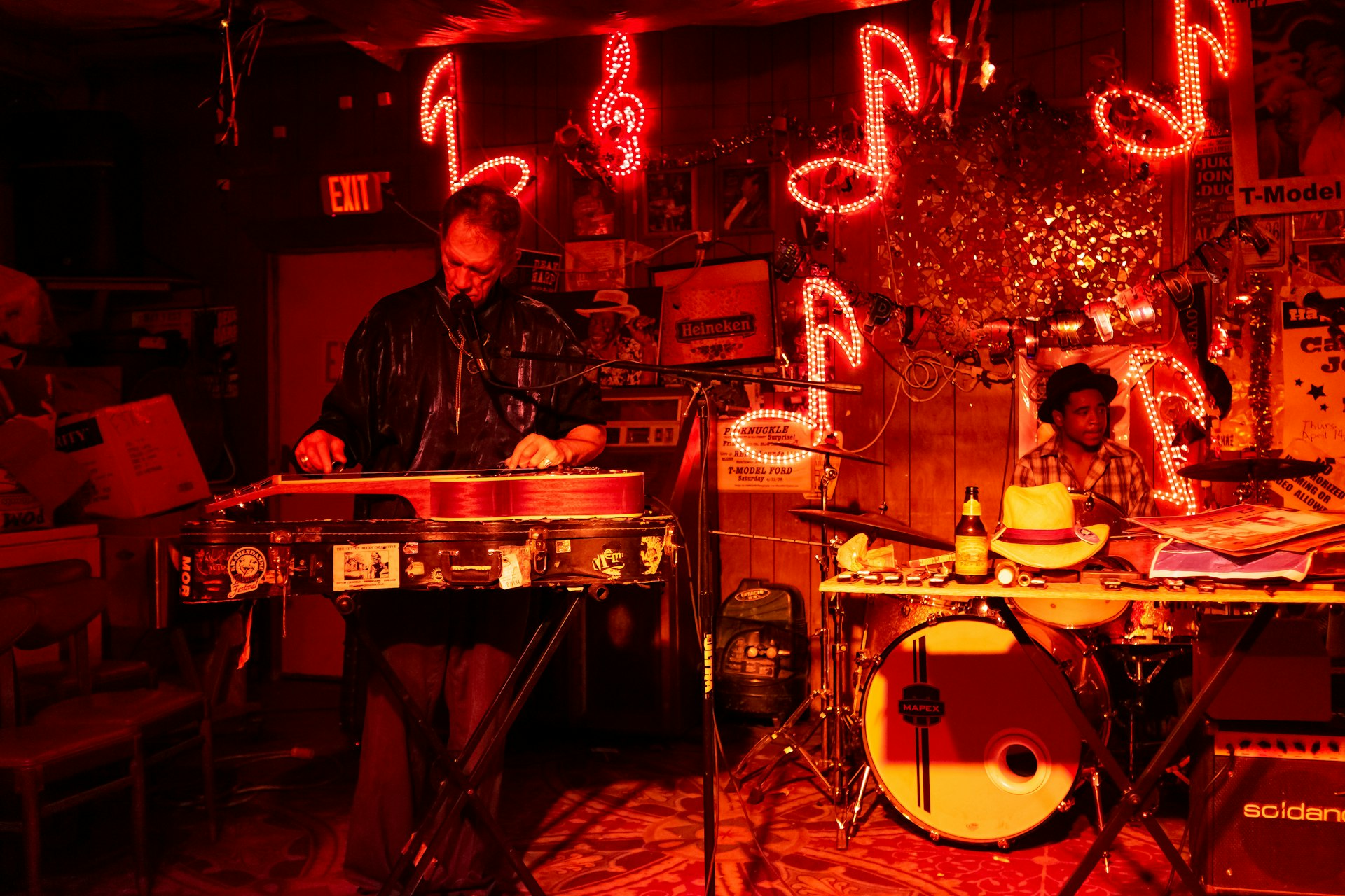 Blues musicians playing under red lights at the Reds Lounge in Clarksdale, Tennessee