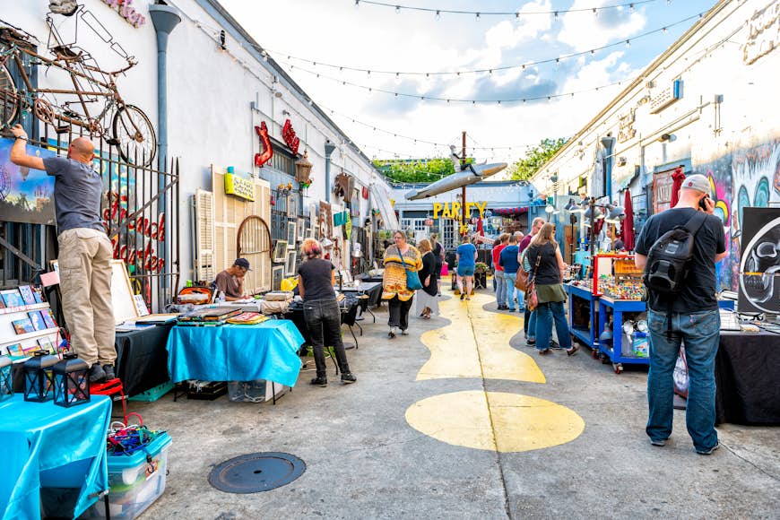 People walk through an art market in New Orleans. 