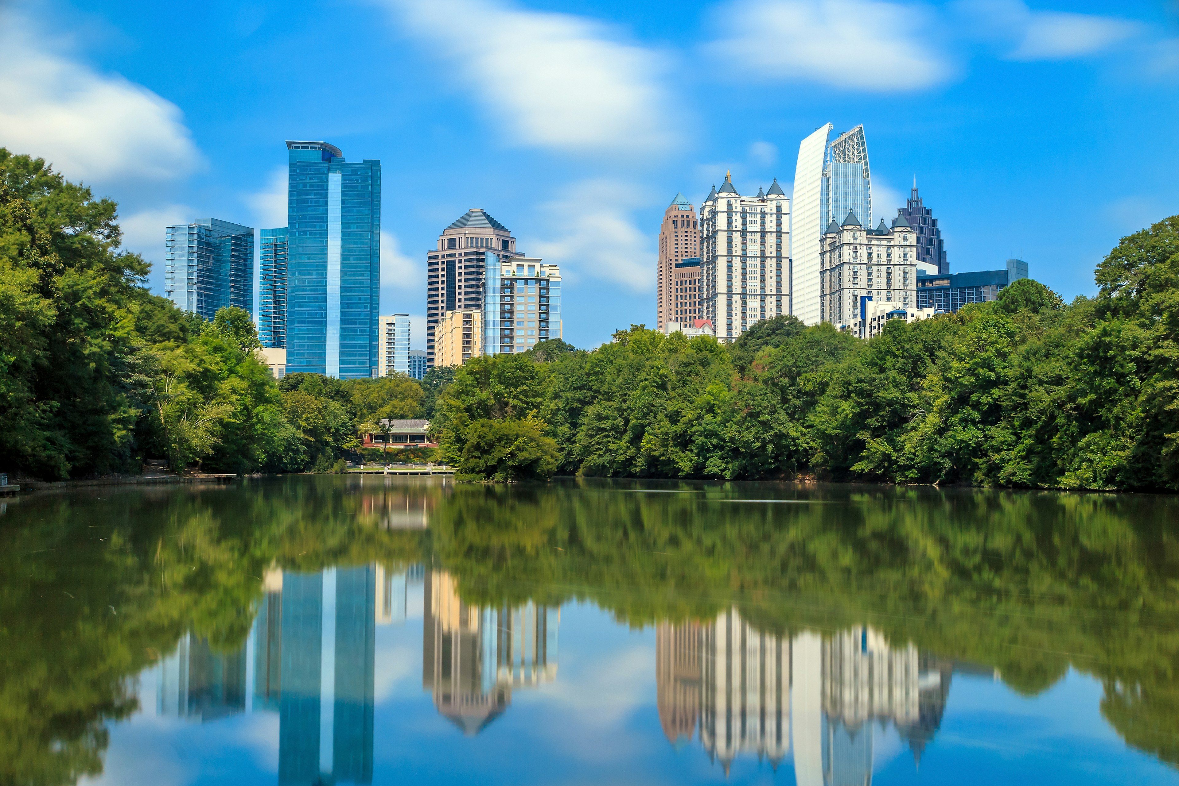 Skyline and reflections of midtown Atlanta, Georgia in Lake Meer from Piedmont Park.
