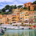 Motor boats and traditional waterside houses in Puerto Soller, Mallorca, Spain.