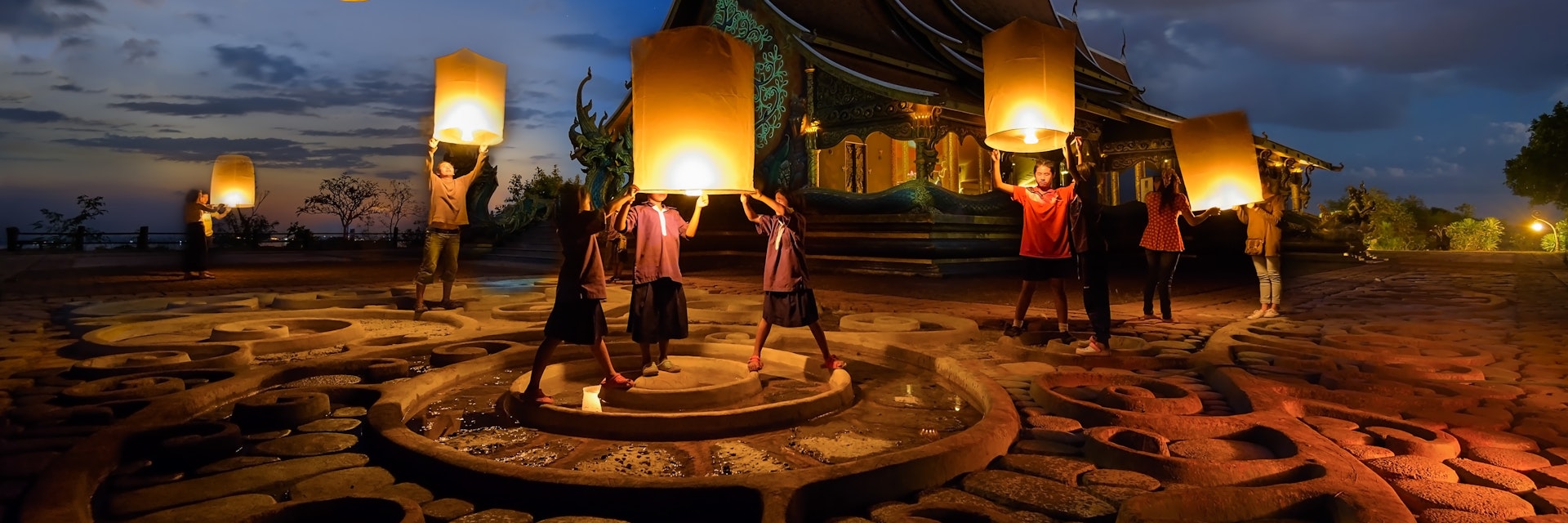People floating lamp in yeepeng festival at pagoda tree glow temple Wat Sirindhorn Wararam.