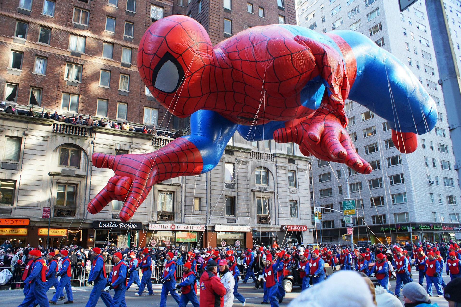 A Spiderman balloon at the  87th Annual Macy's Thanksgiving Day Parade. Spiderman left arm was deflated by a Central Park tree