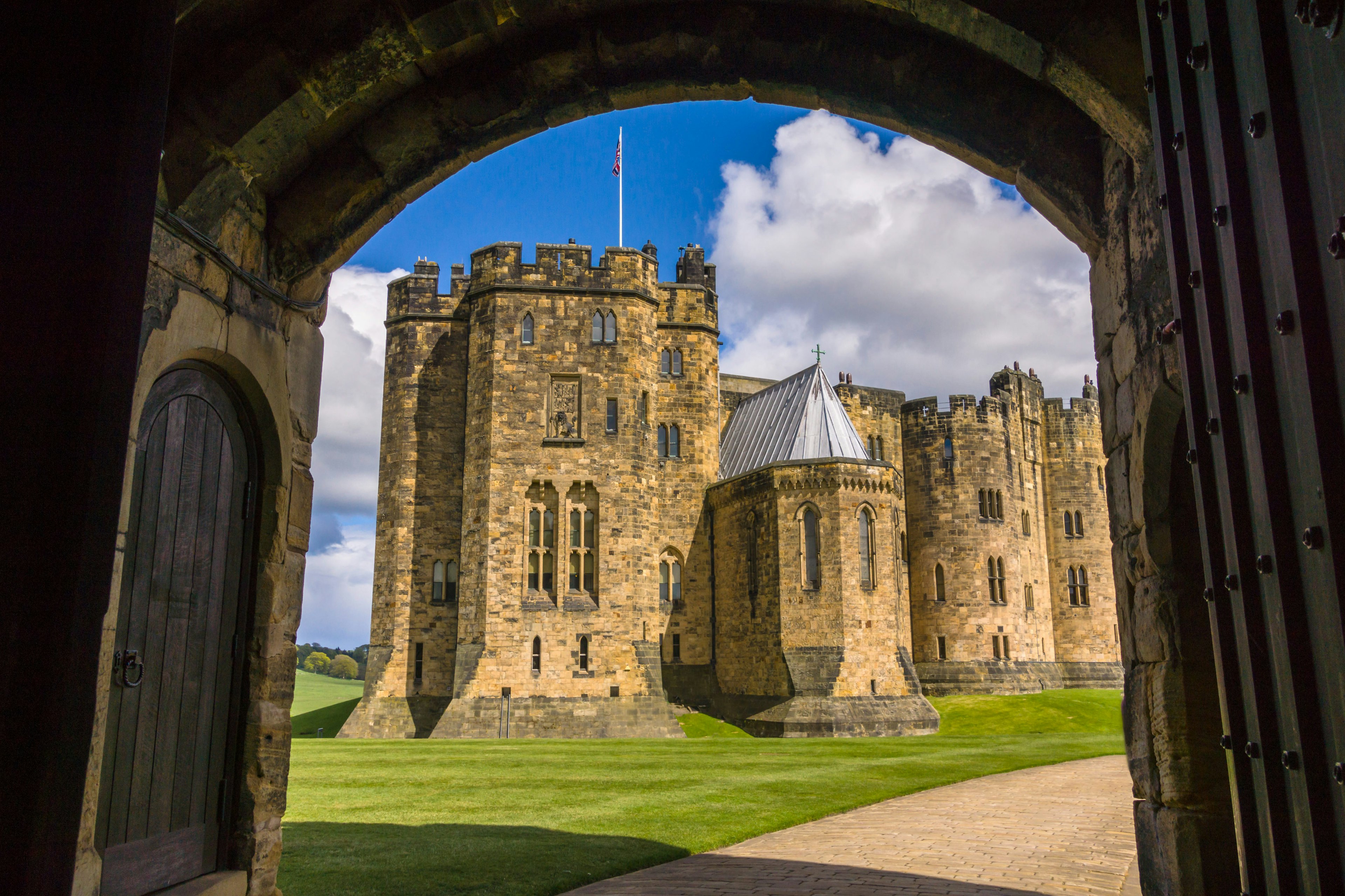 A large castle viewed through an archway