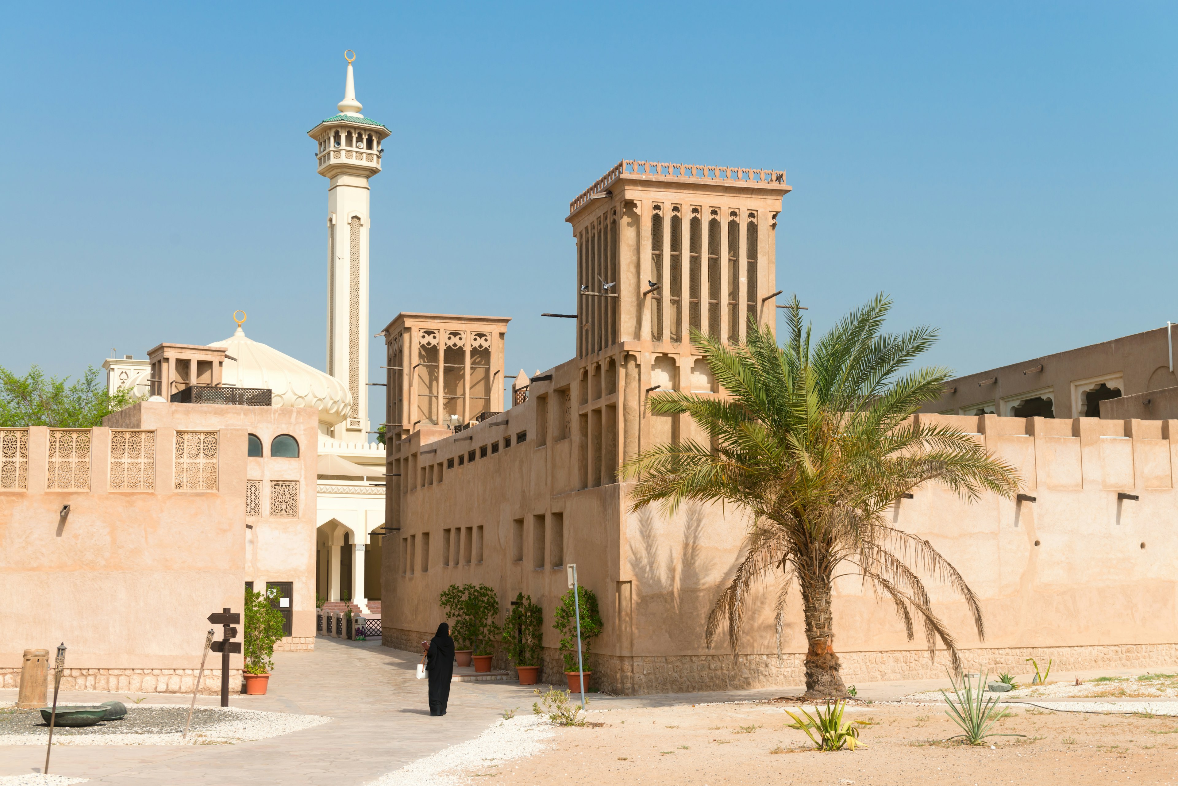 A woman walks through Al Fahidi Historic District in Dubai, United Arab Emirates