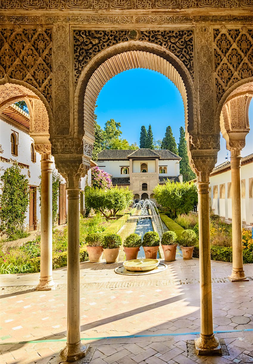 Palacio de Generalife, Alhambra A landscaped garden with fountains viewed through an arched terrace