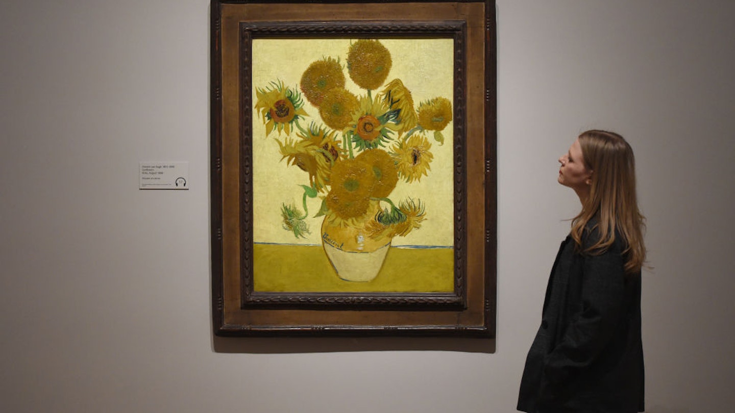 LONDON, ENGLAND - MARCH 25: A woman looks at Vincent van Gogh's Sunflowers painting at the EY Exhibition: Van Gogh and Britain press day which opens at Tate Britain on March 25, 2019 in London, United Kingdom.  (Photo by Stuart C. Wilson/Getty Images)