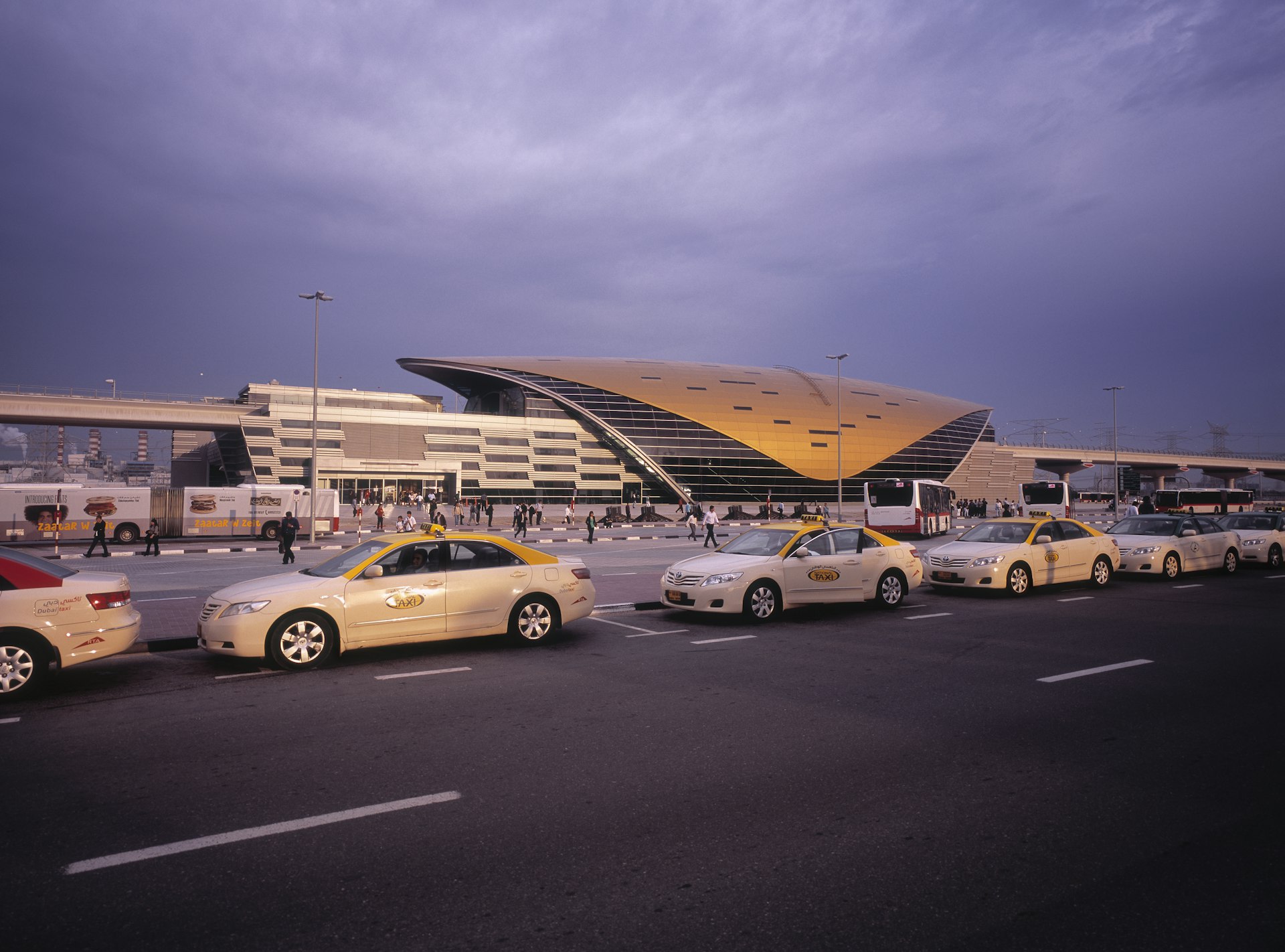 Taxi cabs waiting at a futuristic metro stop in Dubai