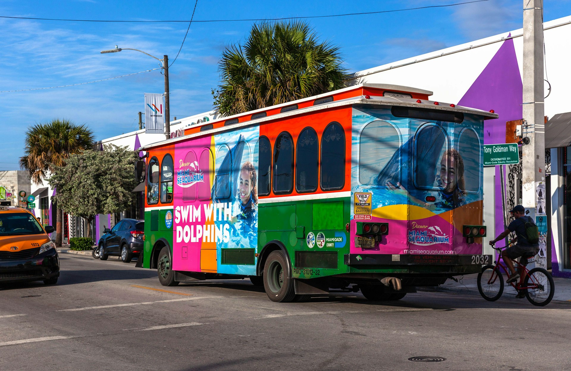 The rear view of a colourful trolley bus going through the Wynwood Art District, Miami, Florida, USA.