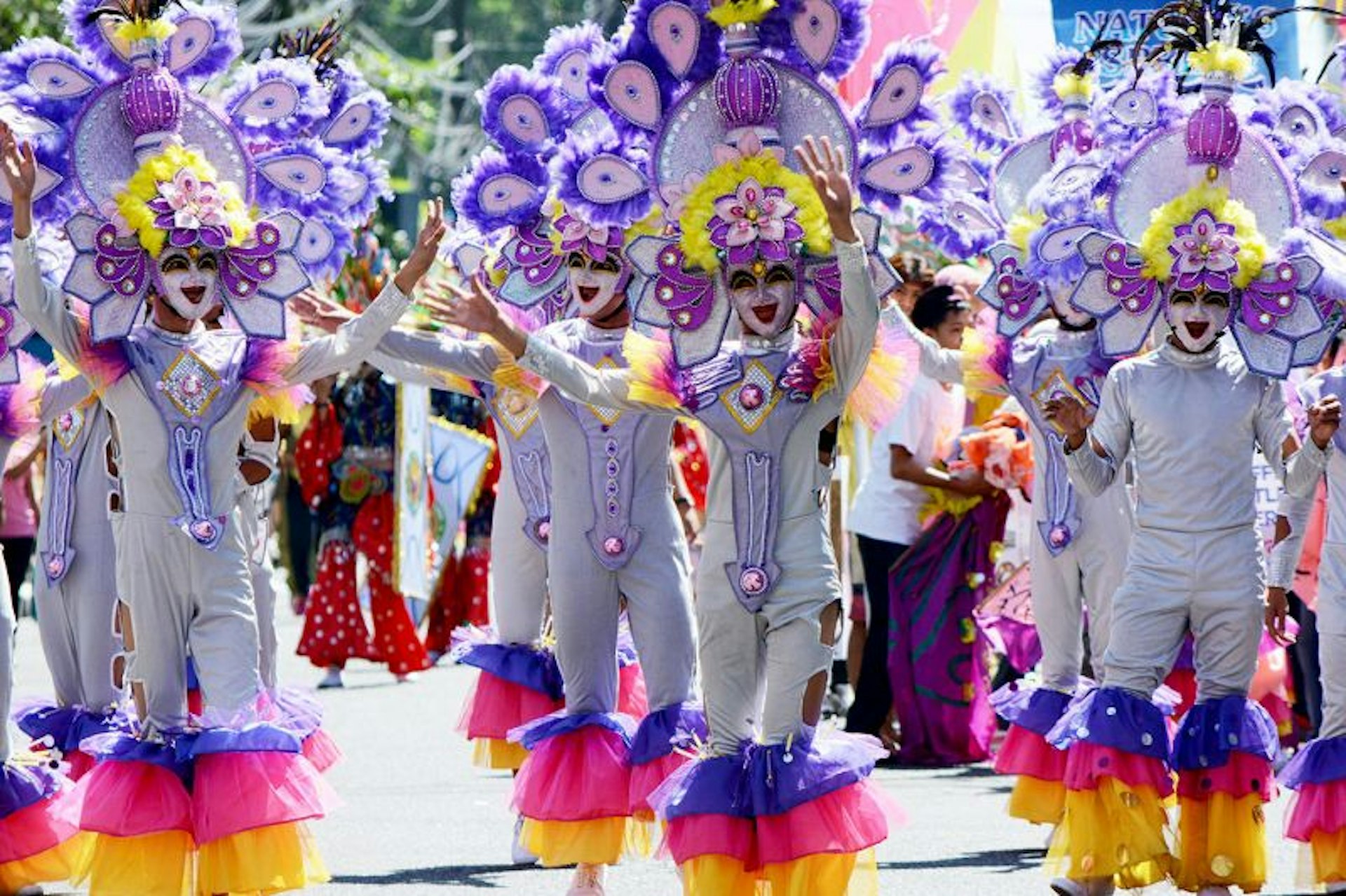 Dancers and performers decked in flamboyant outfits and smiling masks take to the streets for Masskara Festival in the Philippines. 
