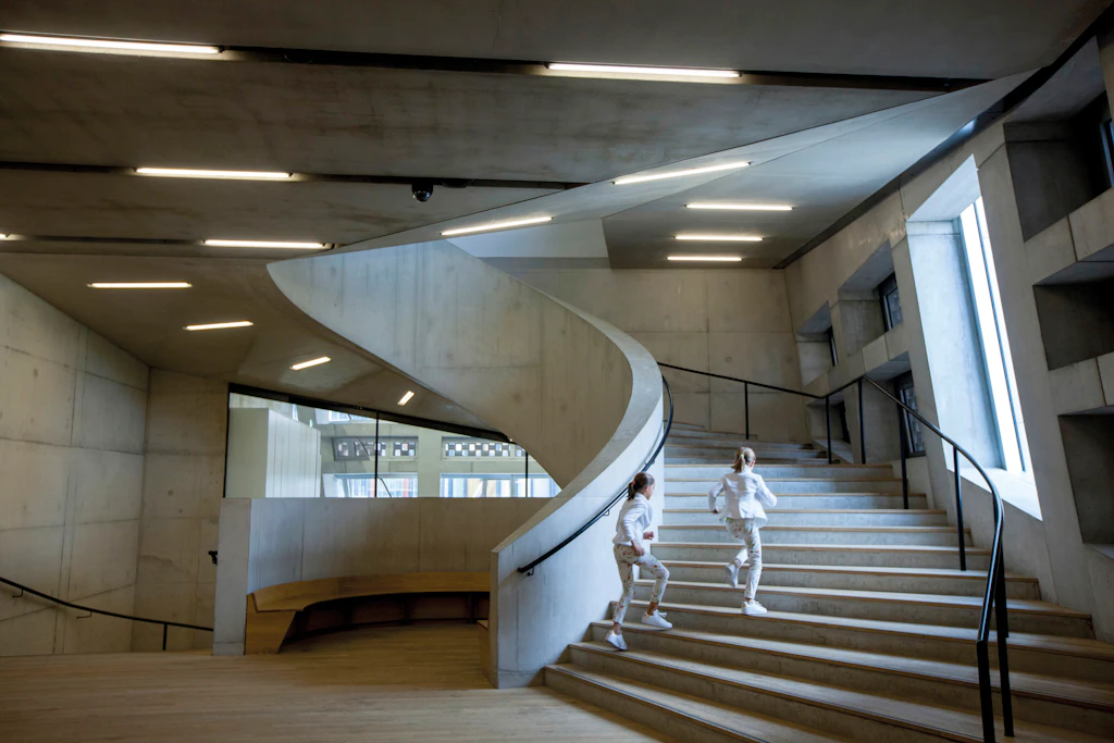Staircase, Blavatnik Building, Tate Modern Two children run up a Brutalist-style concrete spiral staircase