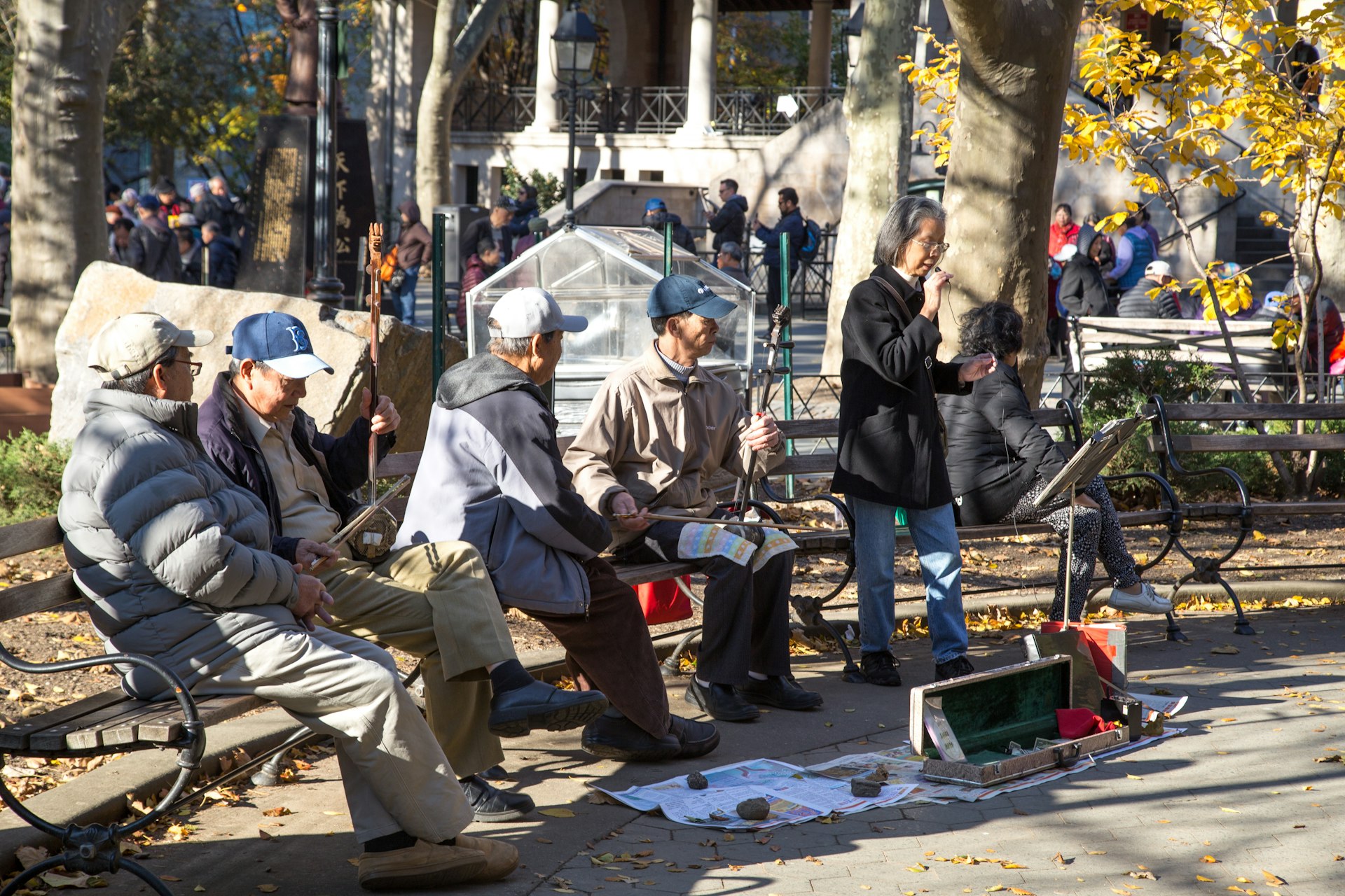A group of elderly Chinese people performing music in Columbus Park in Chinatown 