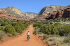 Woman riding her bike in the backcountry near Sedona, Arizona. American Southwest.