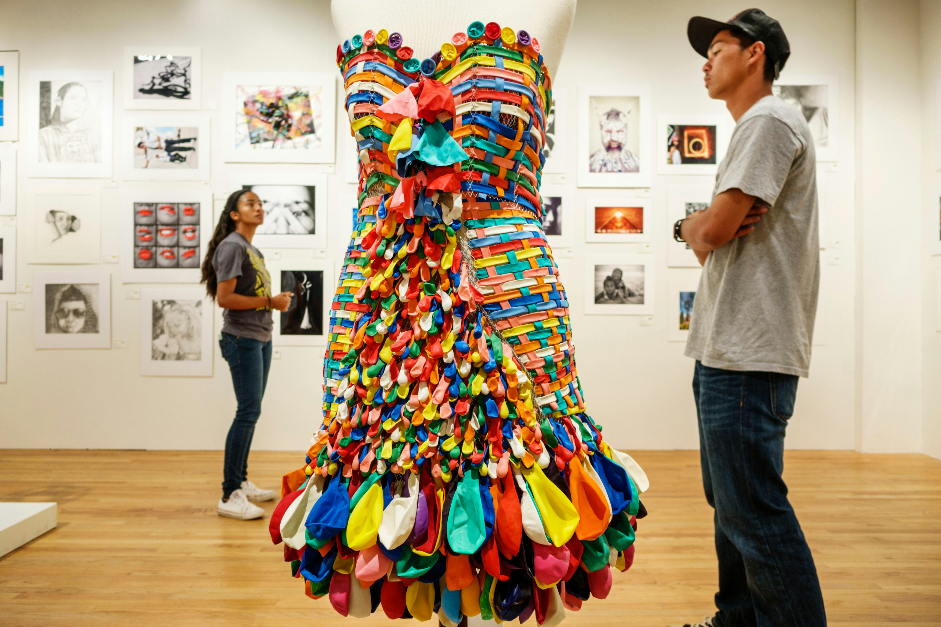 Two visitors look at art exhibits at the Hawaii State Art Museum, Honolulu, Oahu, Hawaii, USA