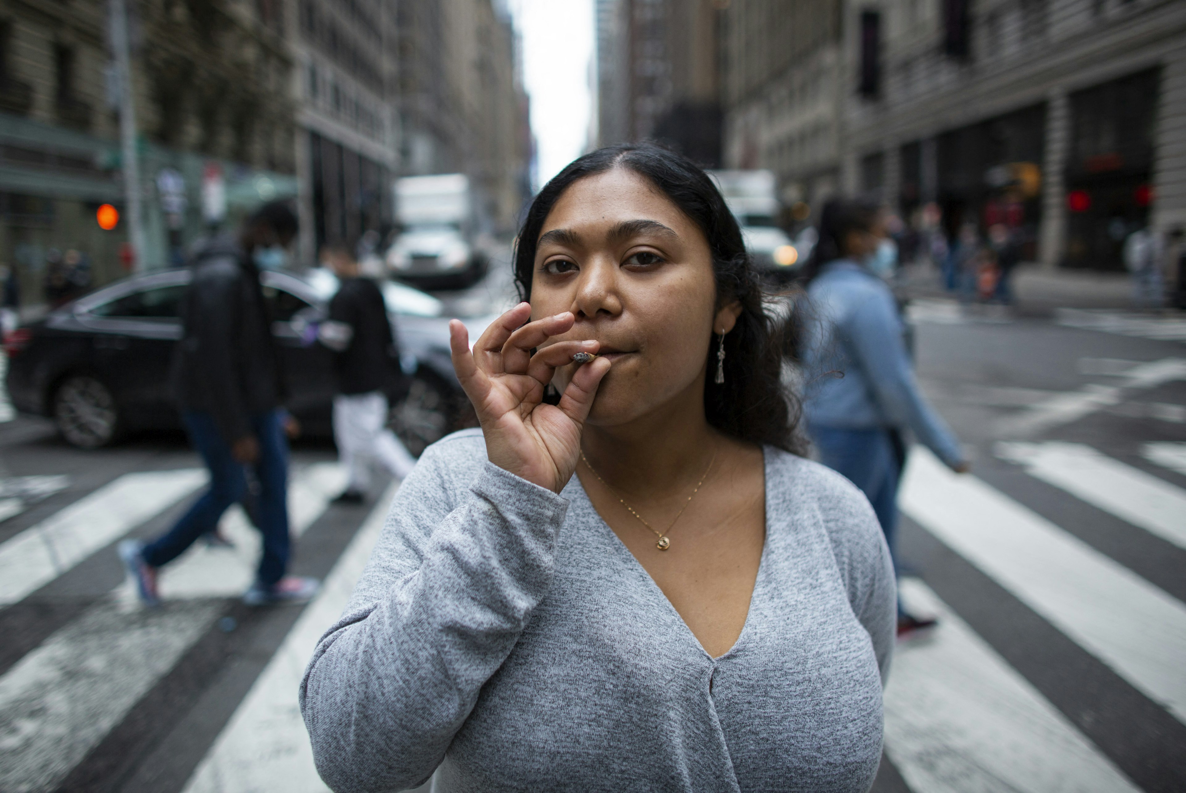Eliana Miss Illi, General Manager of Weed World poses as she smokes a joint on 7th Avenue in Midtown New York City, March 31, 2021. - New York Governor Andrew Cuomo signed legislation legalizing recreational marijuana on March 31. 2021, with a large chunk of tax revenues from sales set to go to minority communities. New York joins 14 other US states and the District of Columbia in permitting cannabis after lawmakers in both state chambers, where Cuomo's Democratic Party holds strong majorities, backed the bill on March 30. (Photo by Kena Betancur / AFP) (Photo by KENA BETANCUR/AFP via Getty Images)