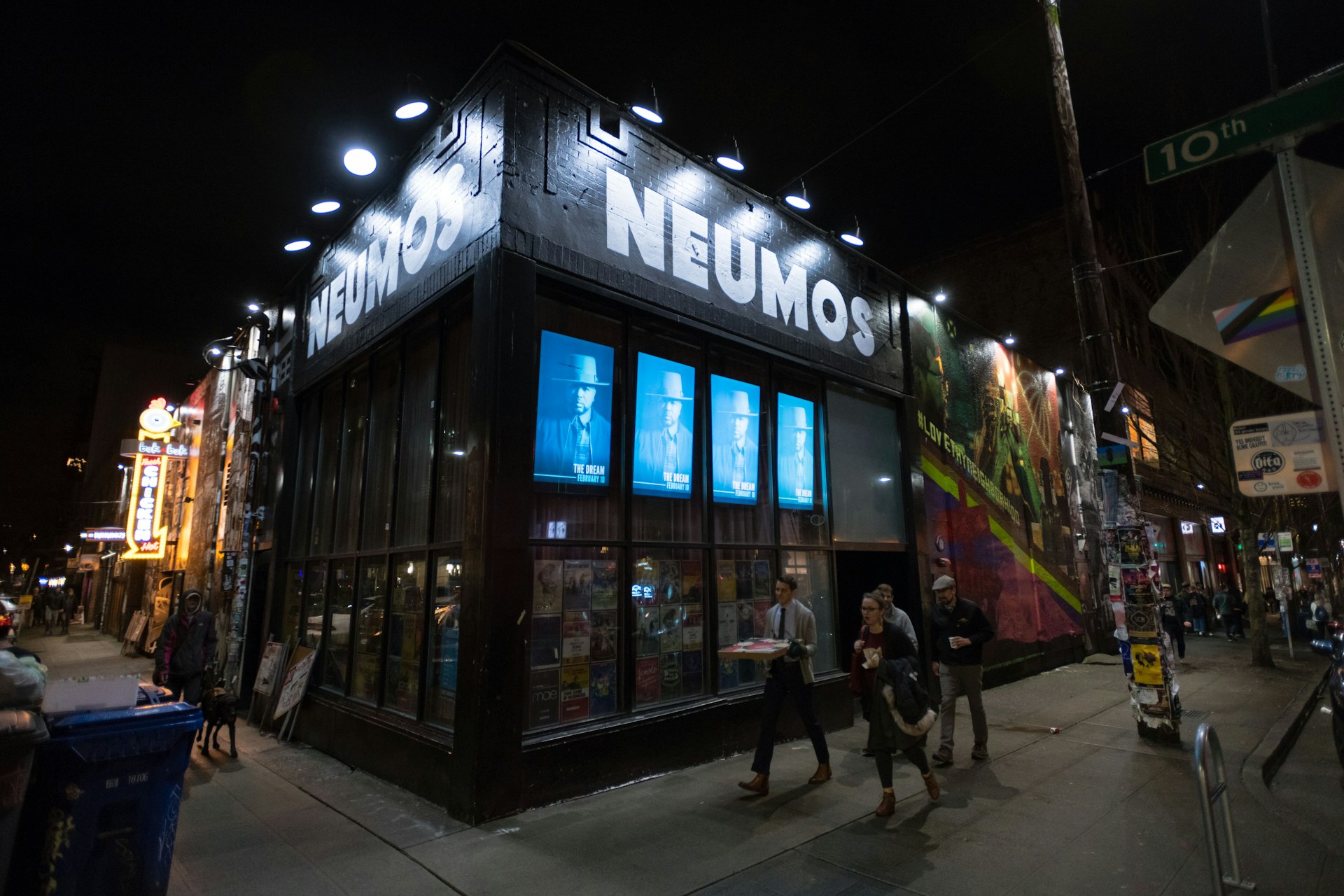People outside of Neumos nightclub in Seattle's Capitol Hill neighborhood at night.