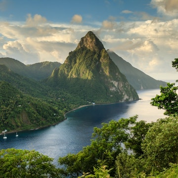View of the Pitons (Petit Piton & Gros Piton) from an elevated viewpoint with the rainforest and bay of Soufrière in the foreground.