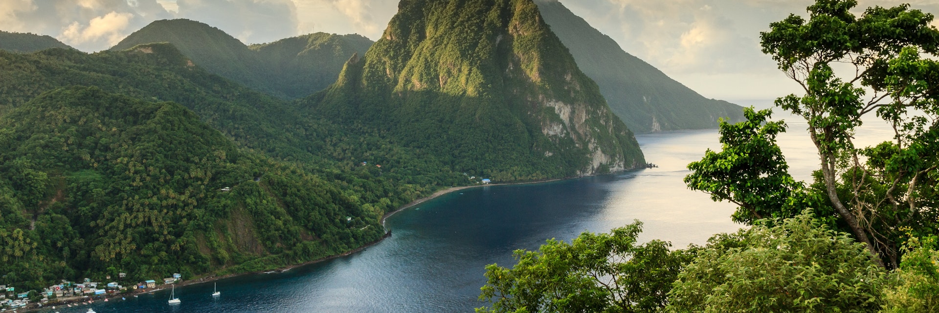 View of the Pitons (Petit Piton & Gros Piton) from an elevated viewpoint with the rainforest and bay of Soufrière in the foreground.