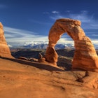 Delicate arch in Arches National Park, Utah with snow capped La sal Mountains in the background