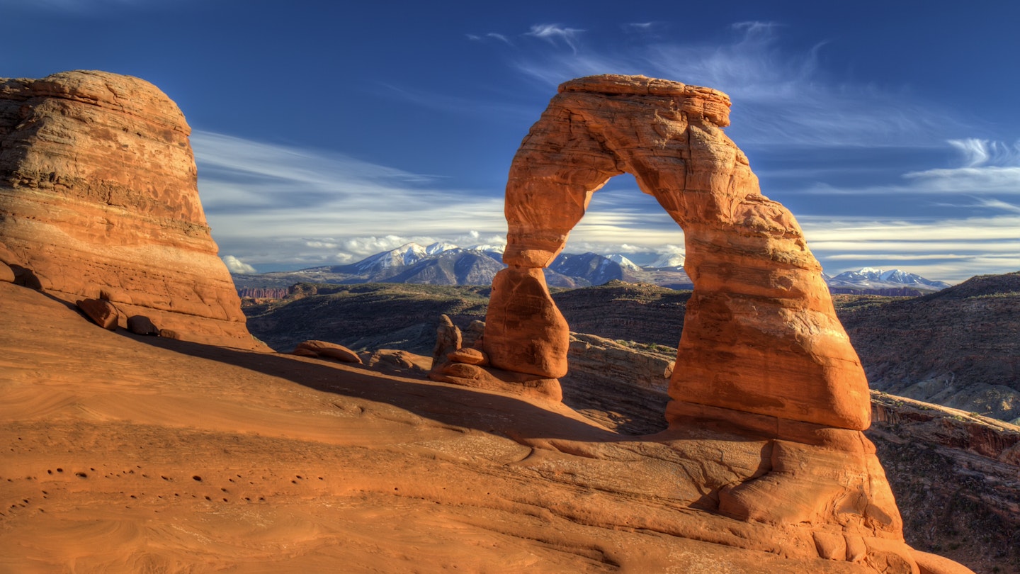Delicate arch in Arches National Park, Utah with snow capped La sal Mountains in the background