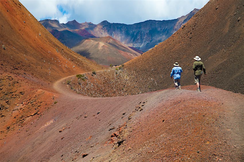 Two hikers in a volcanic landscape at Haleakala National Park 