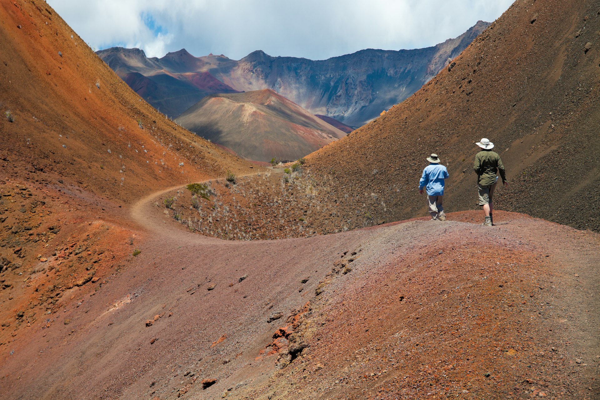 Two hikers in a volcanic landscape at Haleakala National Park 