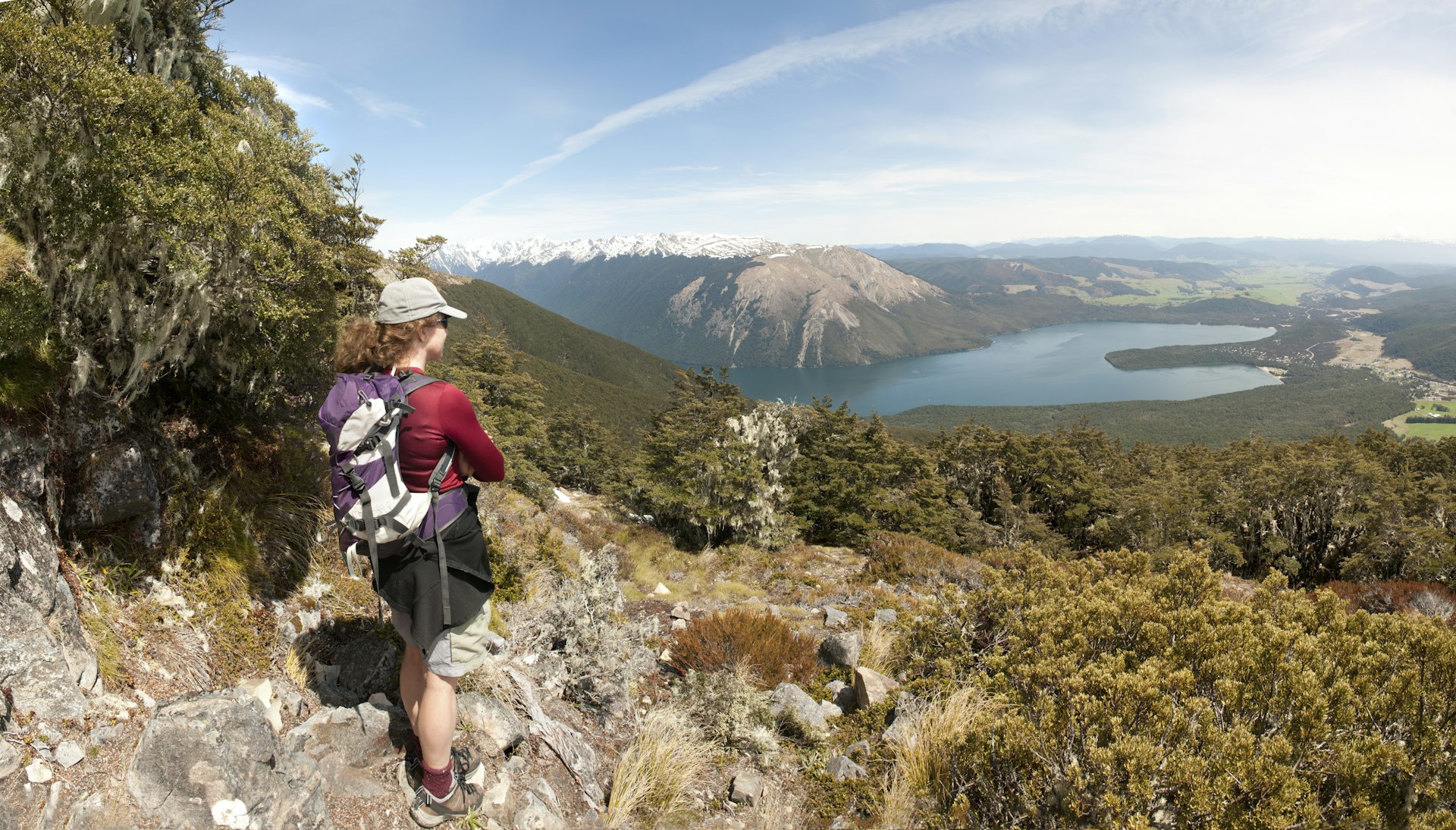 A walker admiring the view of Lake Rotoiti from the St. Arnaud Range in the Nelson Lakes National Park.