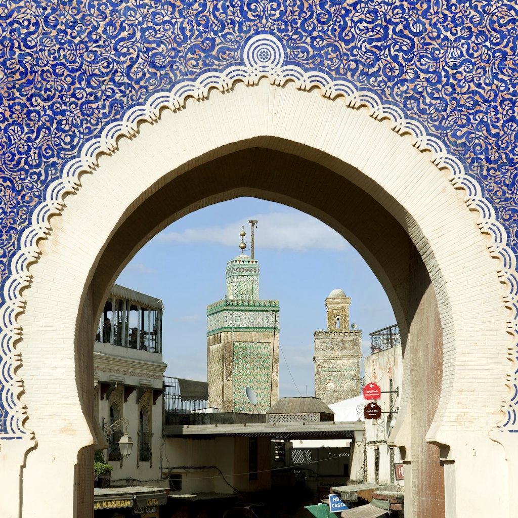 The Bab Bou Jeloud is a recent addition to Fes El Bali, having been built around 1913. The Medersa Bou Inania minaret is framed by this impressive gateway into the Medina