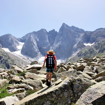 Kid hiking in Pyrenees near Vignemale peak.