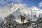 Porter arriving at Mount Everest Base Camp above the Khumbu Glacier in Nepal