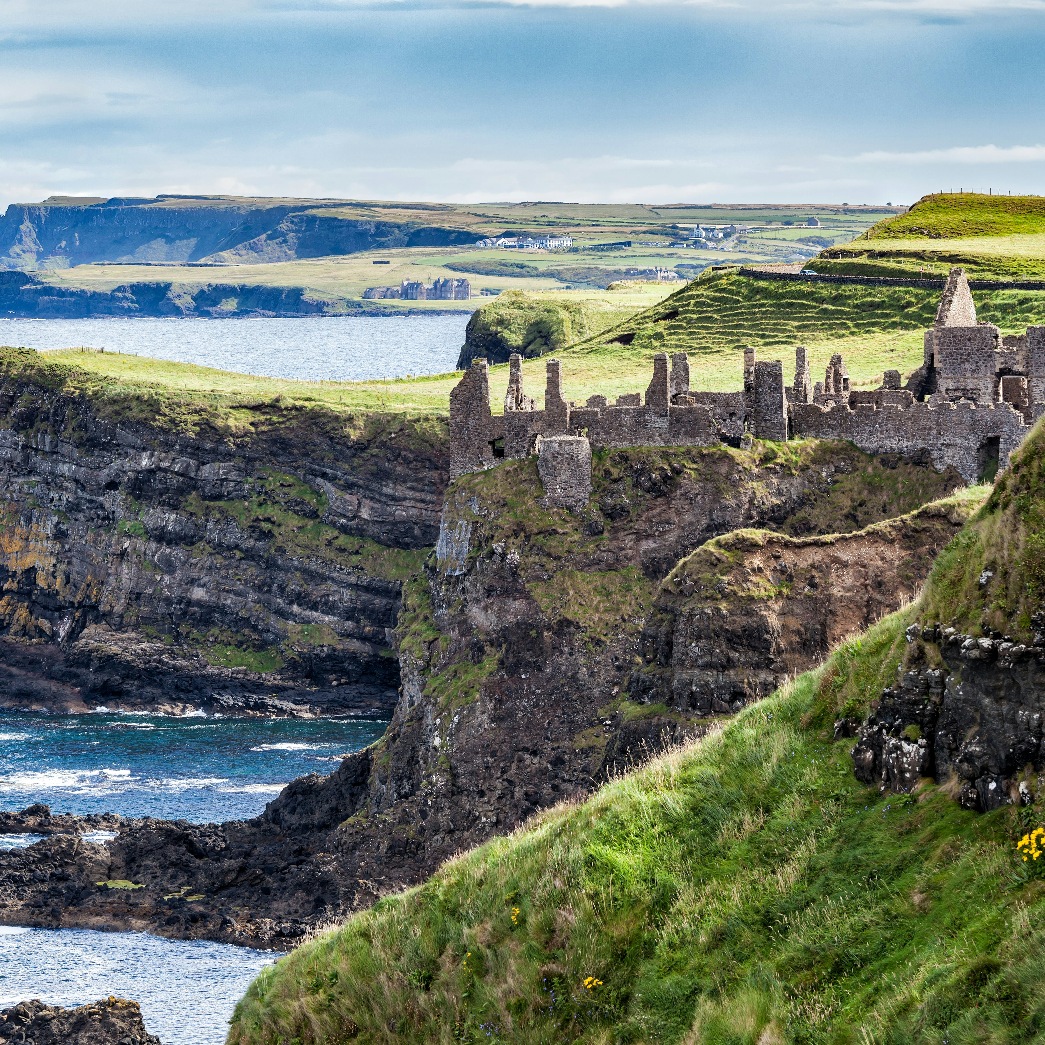 August 7, 2017: Cliffs of Northern Ireland and the ruins of Dunluce Castle Magheracross.