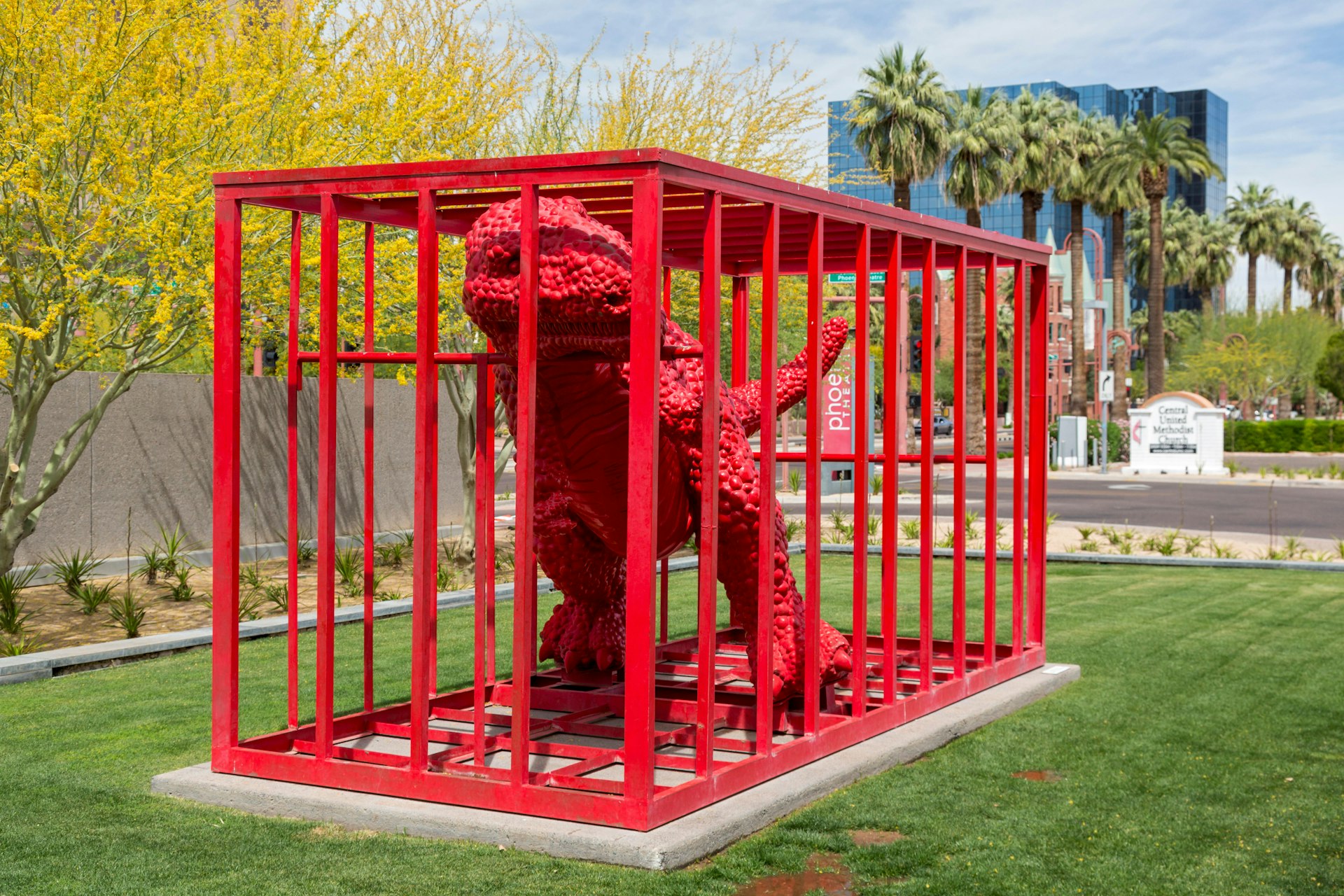 Phoenix, Arizona - A red dinosaur in a red cage at the Phoenix Art Museum.