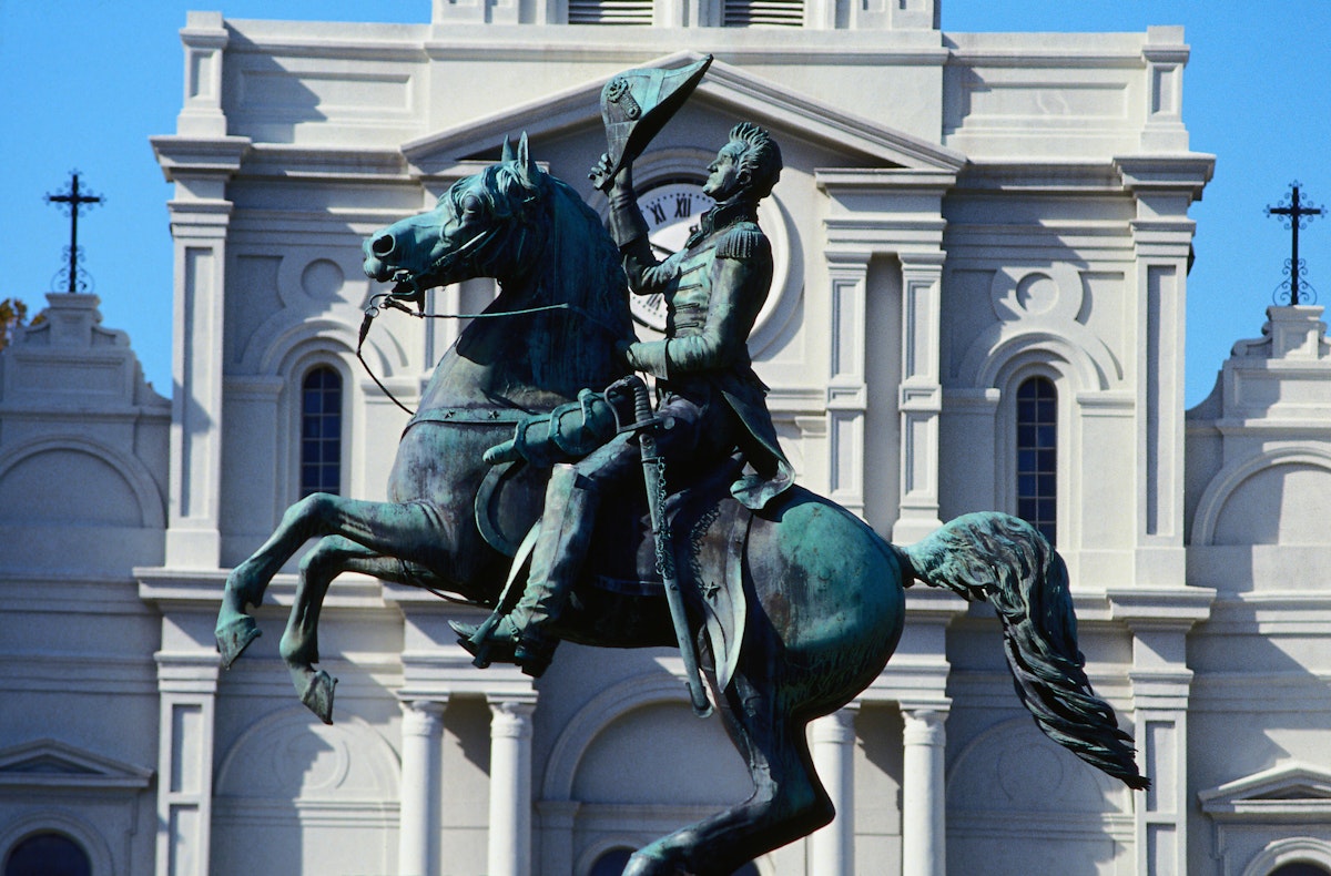 The statue in front of the grand St Louis Cathedral, built in 1794, at one end of Jackson Square in the French Quarter - New Orleans, Louisiana