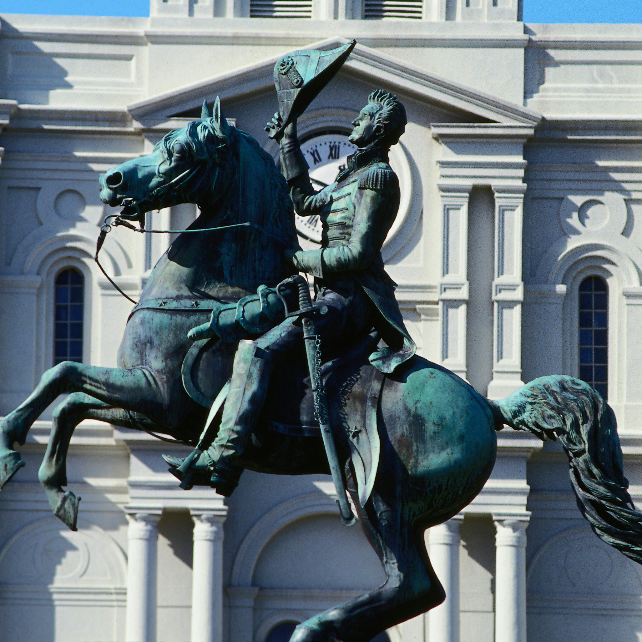 The statue in front of the grand St Louis Cathedral, built in 1794, at one end of Jackson Square in the French Quarter - New Orleans, Louisiana